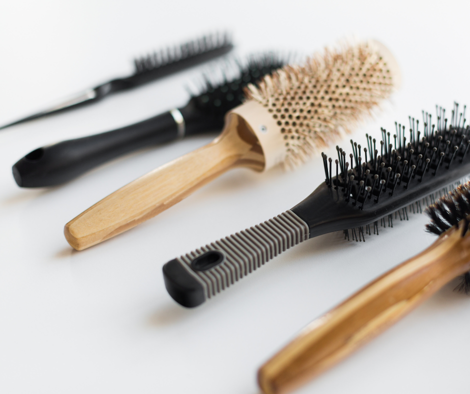 angry woman trying to brush out tangles in her bleached curly hair